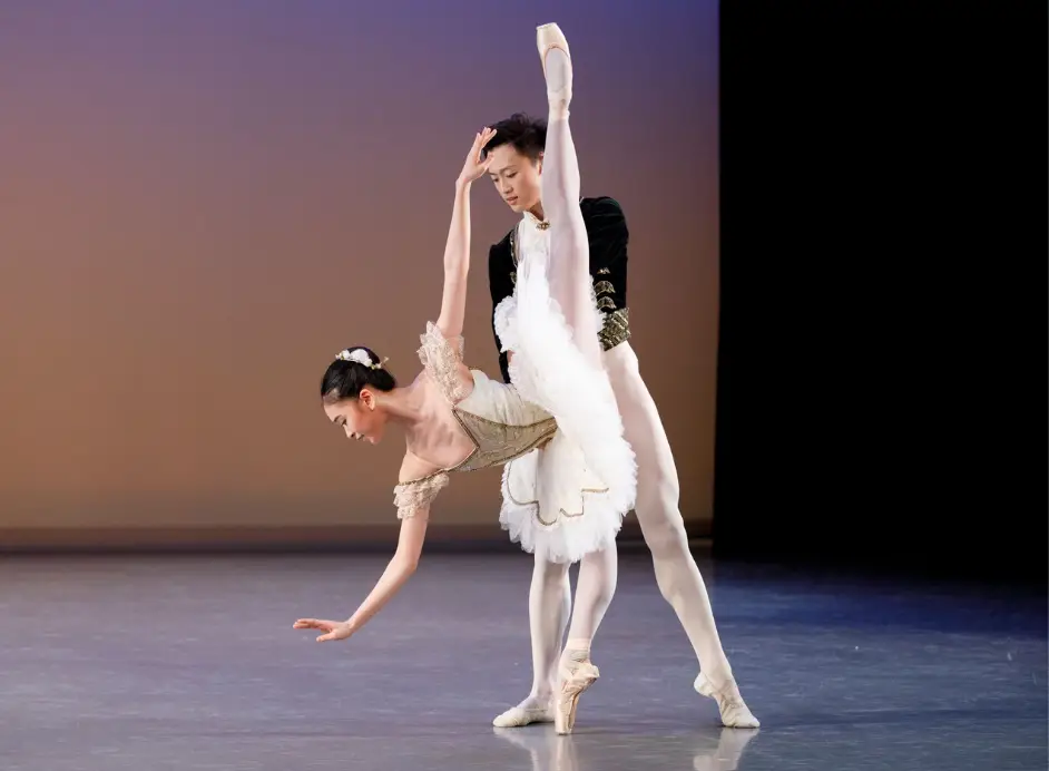 Two dancers perform a pas de deux from the ballet Paquita onstage at the Betty Oliphant Theatre